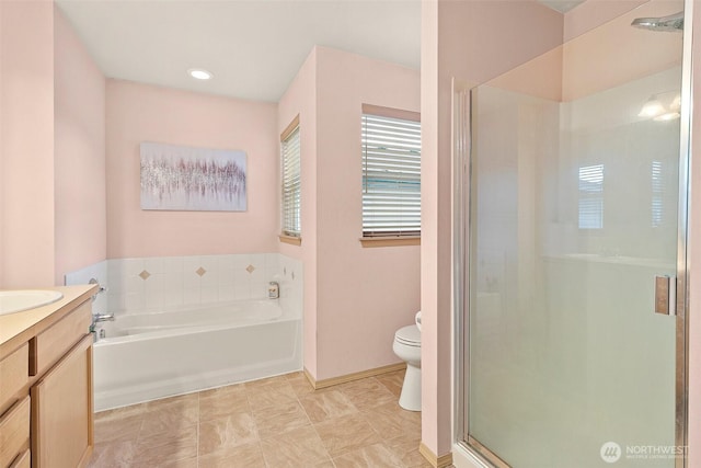 full bath featuring toilet, a stall shower, a garden tub, and vanity