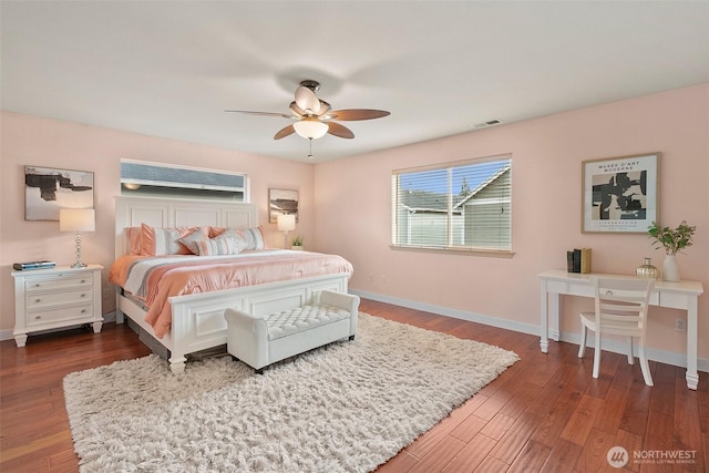 bedroom featuring visible vents, ceiling fan, baseboards, and wood finished floors