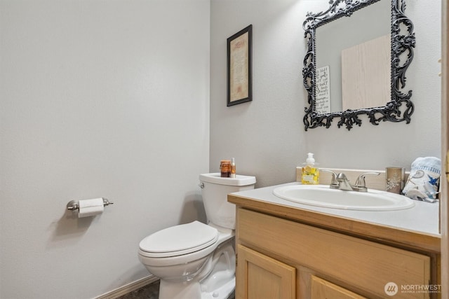 half bathroom featuring toilet and vanity