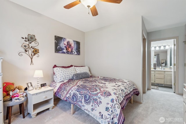 bedroom with light carpet, ceiling fan, and ensuite bath