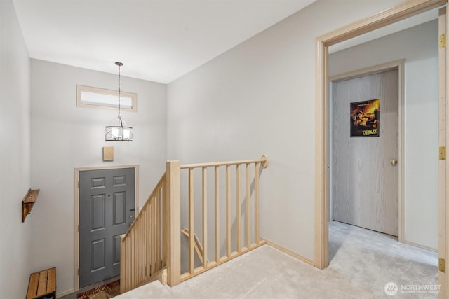 carpeted entrance foyer with baseboards