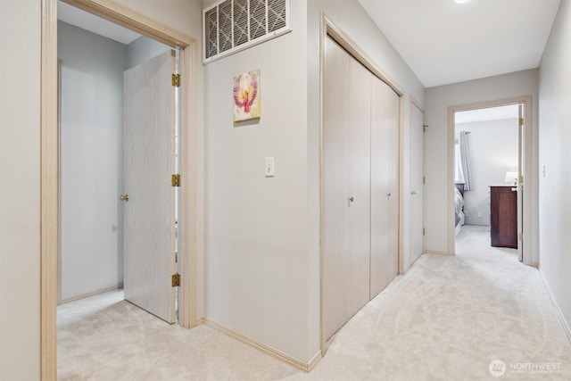 corridor with light carpet and visible vents