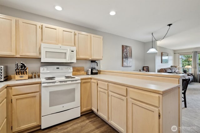 kitchen with white appliances, a peninsula, light countertops, light brown cabinets, and recessed lighting