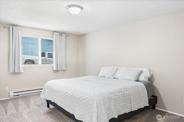 bedroom with a baseboard radiator, baseboards, carpet, and a textured ceiling