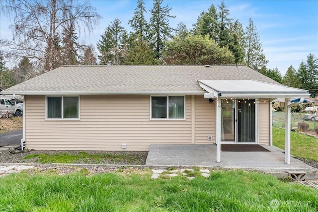 back of house with a patio area and a shingled roof