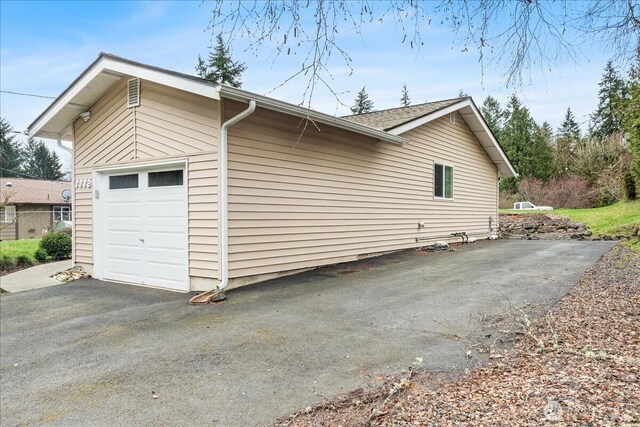 view of side of home featuring driveway