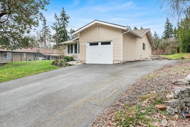 view of front of home featuring a front lawn, a garage, and driveway