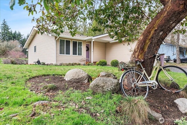 ranch-style home featuring a front yard