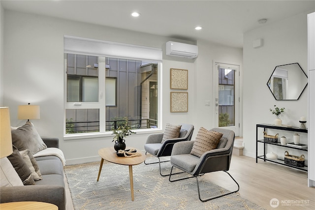 living area with recessed lighting, a wall mounted air conditioner, baseboards, and wood finished floors