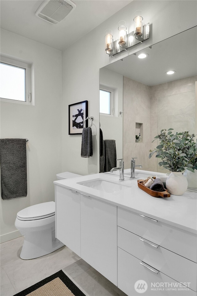 bathroom featuring visible vents, vanity, and toilet