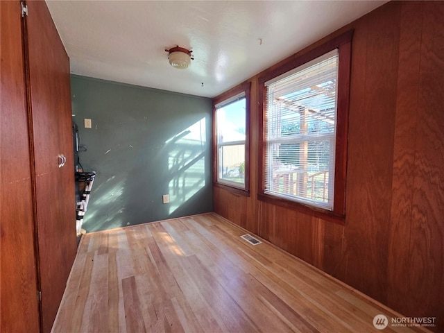 unfurnished room featuring visible vents and wood finished floors