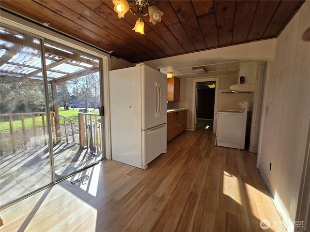 kitchen with washer / dryer, visible vents, wooden ceiling, freestanding refrigerator, and light wood-type flooring