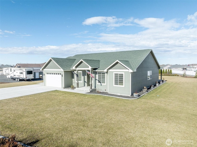 ranch-style house featuring an attached garage, driveway, roof with shingles, and a front yard