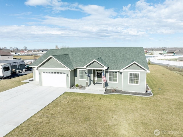 ranch-style house featuring a garage, roof with shingles, driveway, and a front lawn