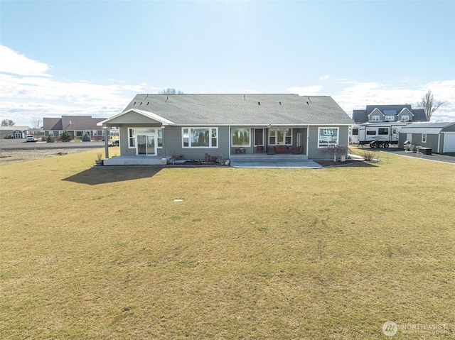 back of property featuring a patio and a lawn