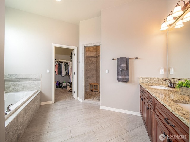 full bathroom featuring a sink, tiled shower, a bath, double vanity, and an inviting chandelier