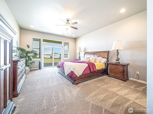 bedroom with carpet floors, access to outside, and multiple windows