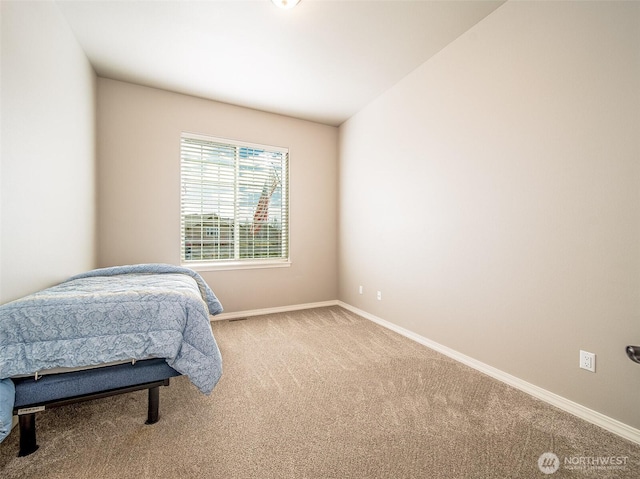 bedroom featuring carpet and baseboards