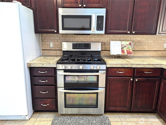 kitchen with reddish brown cabinets, tasteful backsplash, tile countertops, and stainless steel appliances