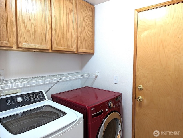 laundry area featuring cabinet space and washing machine and clothes dryer