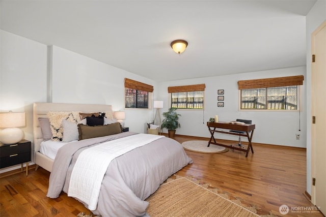 bedroom featuring baseboards and wood finished floors