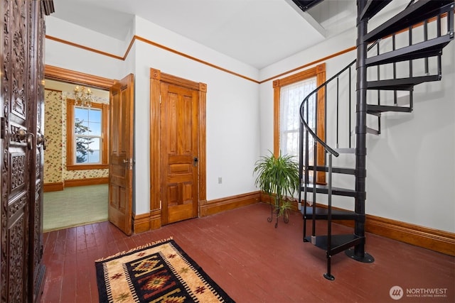 entryway featuring stairs, hardwood / wood-style flooring, and baseboards