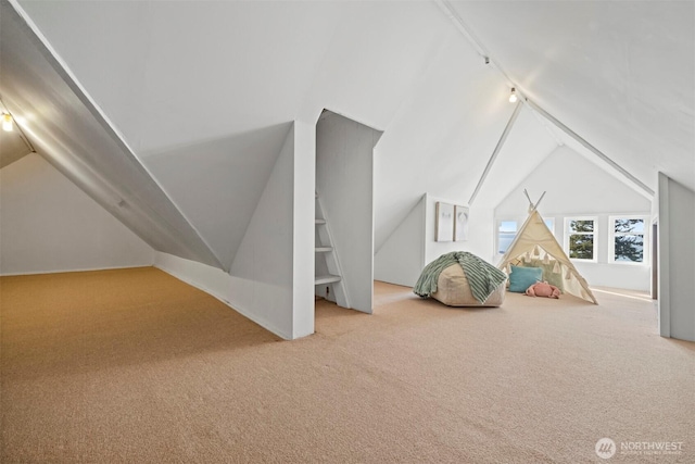 game room with carpet floors, vaulted ceiling, and track lighting