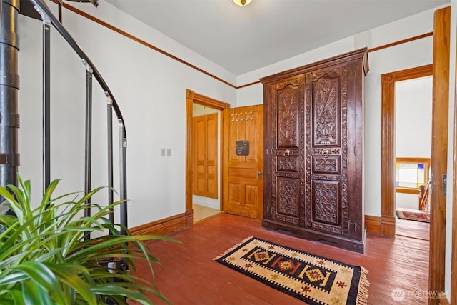 entryway with baseboards and wood finished floors