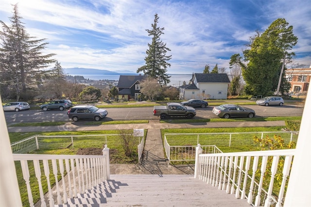 deck with a lawn and fence