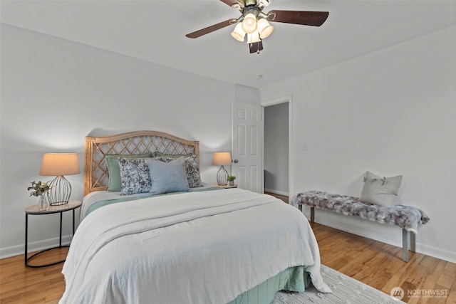 bedroom featuring ceiling fan, baseboards, and wood finished floors