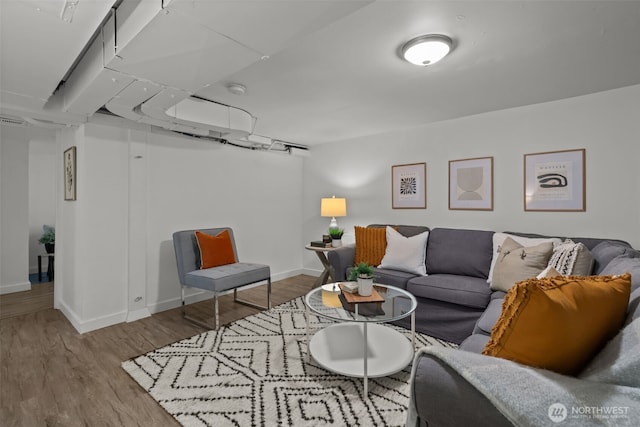 living room featuring baseboards and wood finished floors