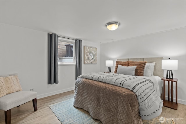 bedroom featuring baseboards and light wood finished floors