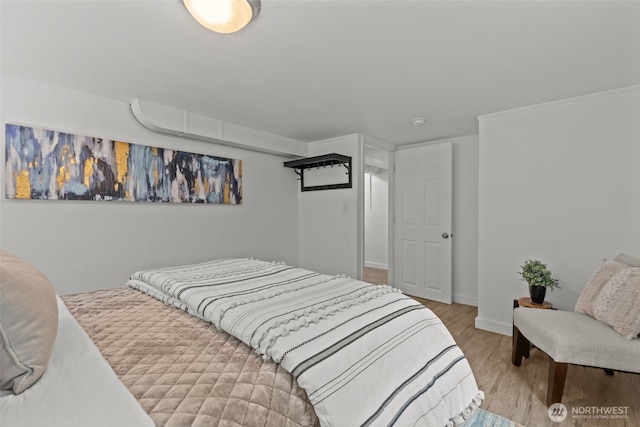 bedroom with baseboards and wood finished floors