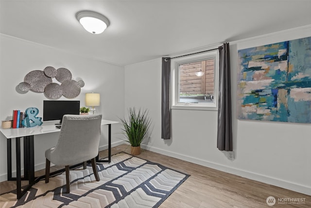 home office with baseboards and wood finished floors