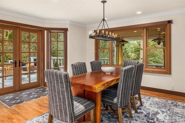 dining room featuring ornamental molding, french doors, baseboards, and wood finished floors