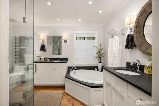 full bathroom with a stall shower, a sink, a bath, and crown molding