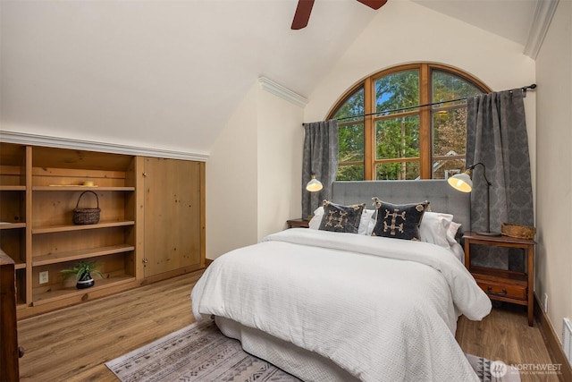 bedroom featuring ceiling fan, vaulted ceiling, baseboards, and wood finished floors