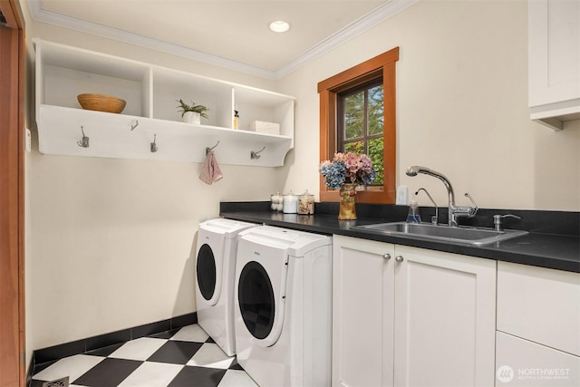 clothes washing area featuring cabinet space, tile patterned floors, crown molding, washing machine and dryer, and a sink