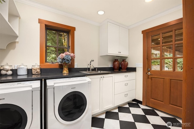 clothes washing area featuring dark floors, a sink, and washing machine and clothes dryer