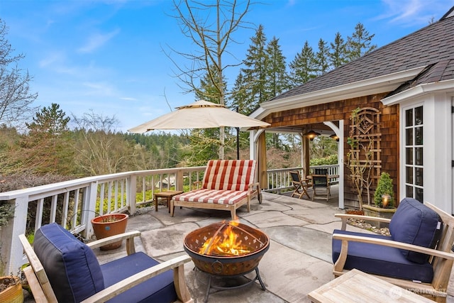 deck with a patio area and an outdoor fire pit