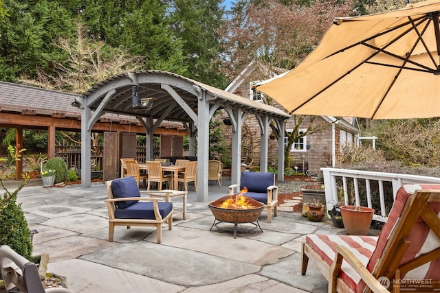 view of patio / terrace featuring an outdoor fire pit and a gazebo