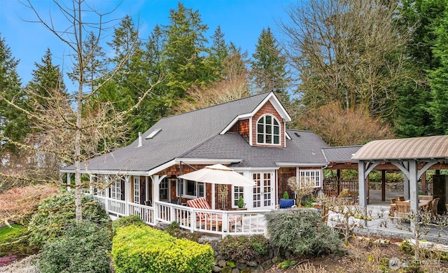 rear view of property featuring a gazebo