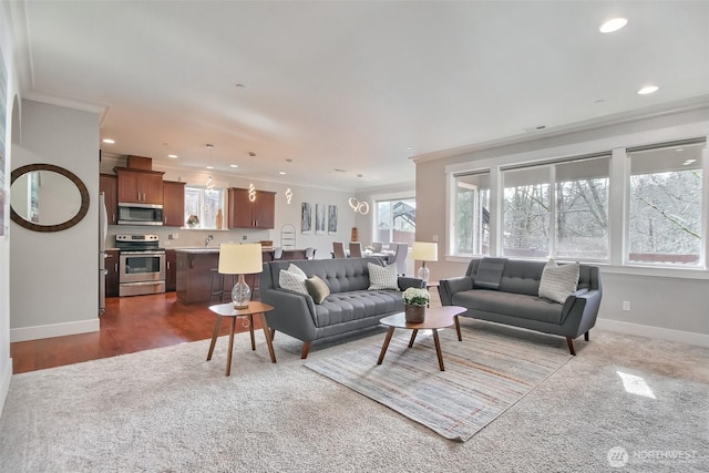 living room with recessed lighting, crown molding, and baseboards