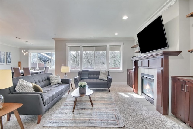 living area featuring light carpet, baseboards, crown molding, a fireplace, and recessed lighting
