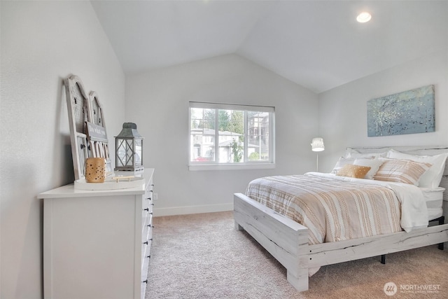 bedroom featuring vaulted ceiling, baseboards, and light colored carpet