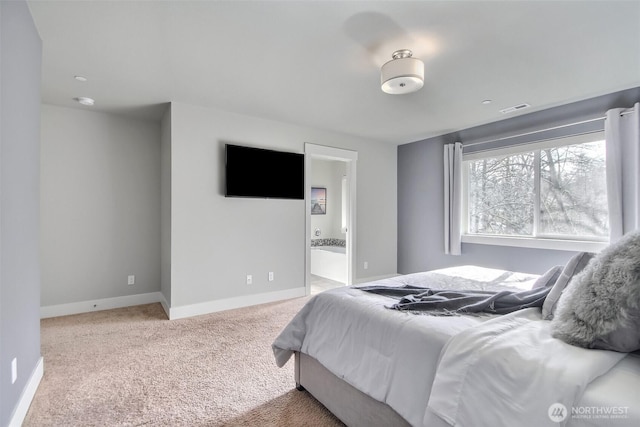 bedroom with carpet, ensuite bath, visible vents, and baseboards