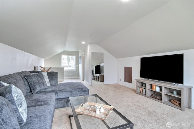 carpeted living room with lofted ceiling and baseboards