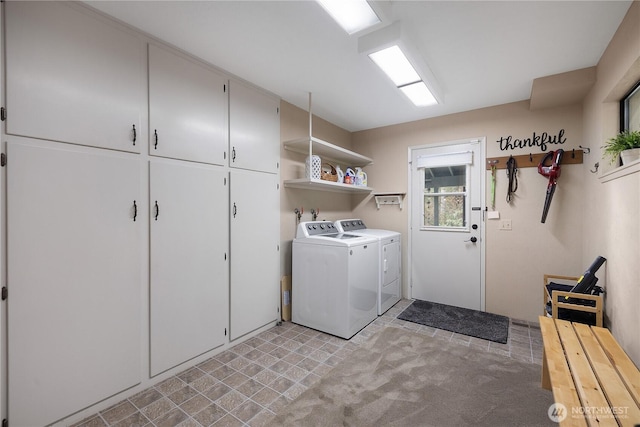 laundry area with cabinet space and independent washer and dryer