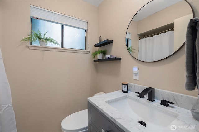 bathroom featuring toilet and vanity