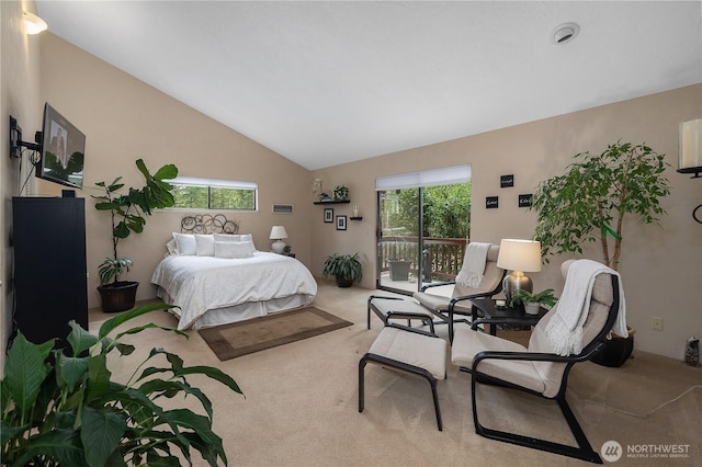 carpeted bedroom featuring access to outside and vaulted ceiling